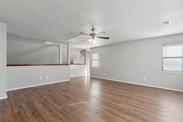 unfurnished room featuring lofted ceiling, a textured ceiling, ceiling fan, and dark hardwood / wood-style floors