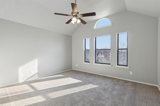 carpeted empty room with high vaulted ceiling and ceiling fan