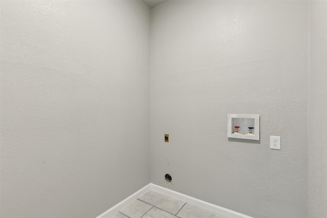 laundry area with hookup for an electric dryer, light tile patterned floors, and washer hookup