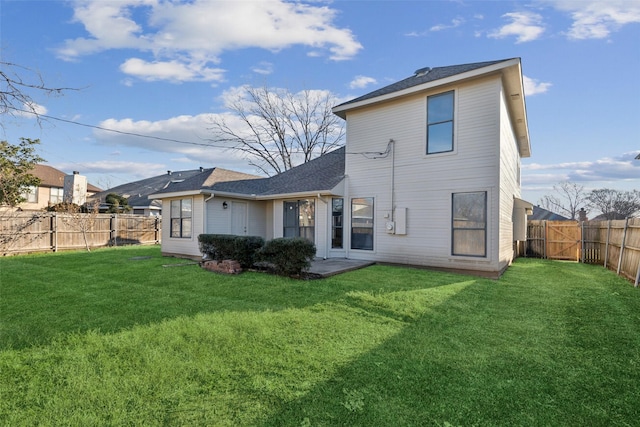 rear view of property featuring a lawn