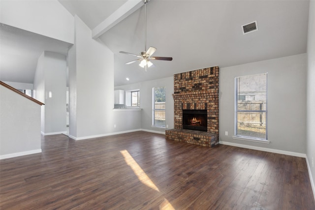 unfurnished living room featuring ceiling fan, dark hardwood / wood-style flooring, high vaulted ceiling, a fireplace, and beam ceiling