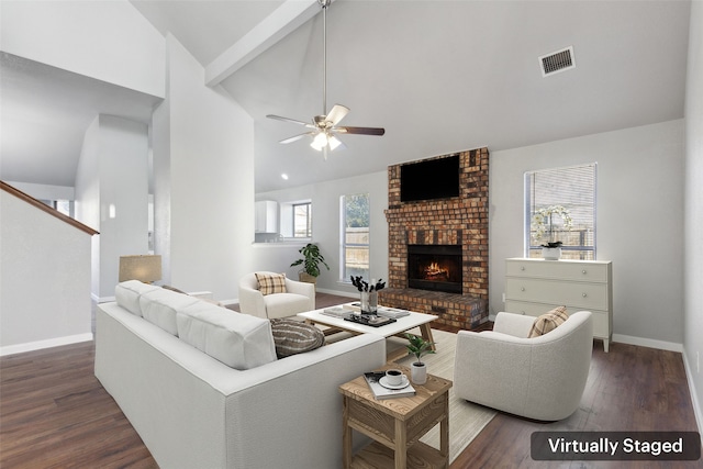 living room featuring a fireplace, plenty of natural light, and dark wood-type flooring