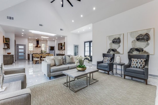 living room with ceiling fan and high vaulted ceiling