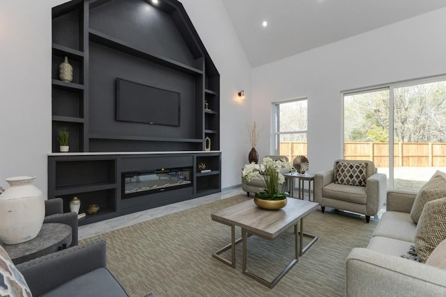 living room with built in features and high vaulted ceiling