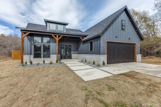 view of front of home with french doors, a front lawn, and a garage