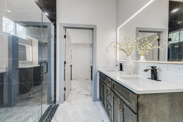 bathroom featuring an enclosed shower and vanity