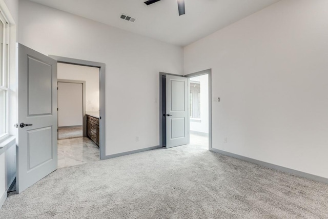 unfurnished bedroom featuring light colored carpet and ceiling fan