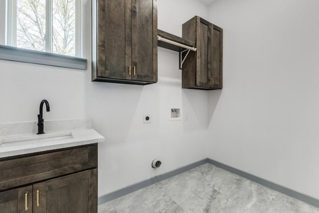 clothes washing area with hookup for a washing machine, cabinets, hookup for an electric dryer, and sink