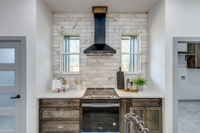 kitchen with tasteful backsplash, a healthy amount of sunlight, stainless steel electric stove, and wall chimney exhaust hood