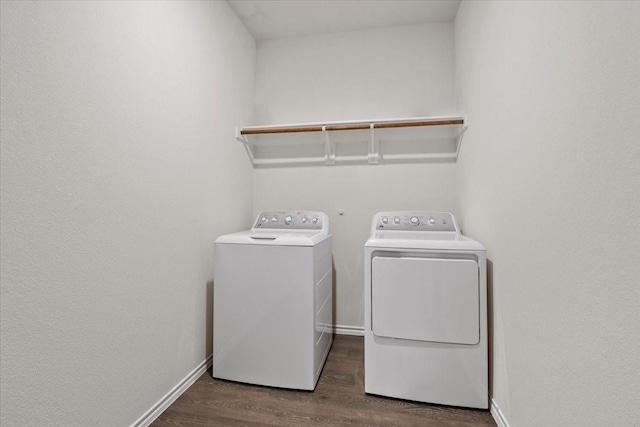 clothes washing area featuring separate washer and dryer and dark hardwood / wood-style flooring