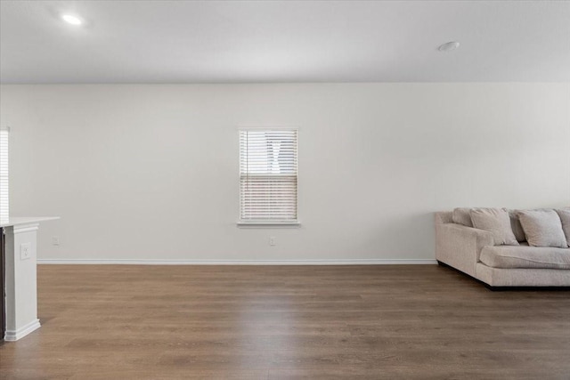 unfurnished living room featuring dark hardwood / wood-style flooring