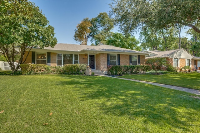 ranch-style home with a front lawn