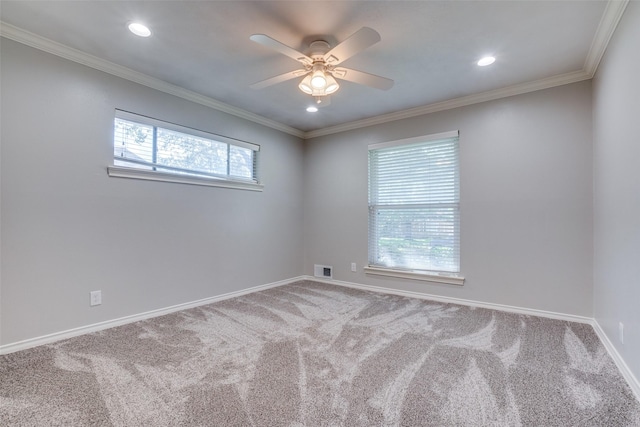 unfurnished room with a healthy amount of sunlight, crown molding, and carpet floors