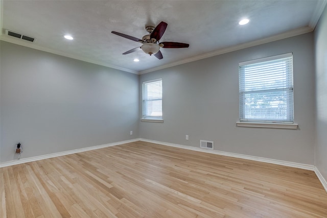 spare room featuring ceiling fan, ornamental molding, and light hardwood / wood-style floors