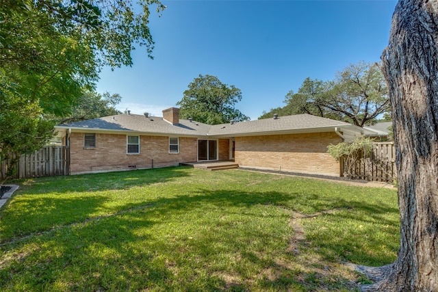 back of property featuring a lawn