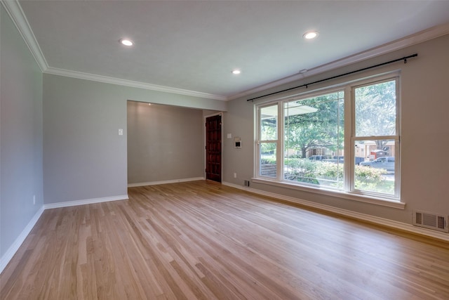 unfurnished room featuring crown molding and light hardwood / wood-style flooring