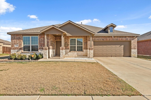 view of front of property featuring a front lawn and a garage