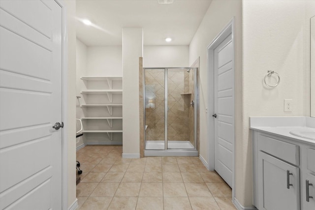 bathroom featuring an enclosed shower, vanity, and tile patterned flooring