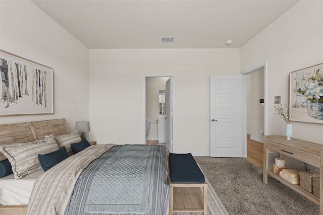 carpeted bedroom with ensuite bath