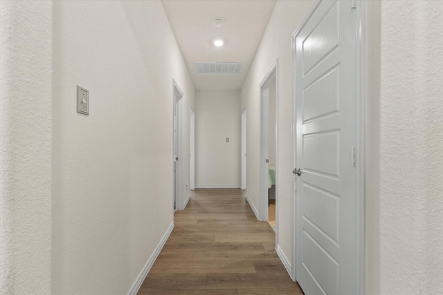 corridor featuring hardwood / wood-style flooring