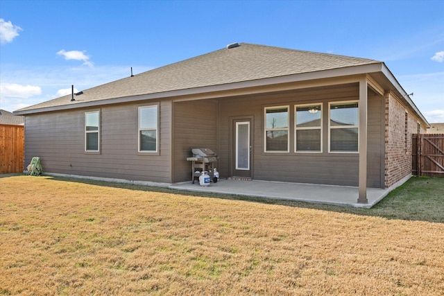 back of house with a lawn and a patio area