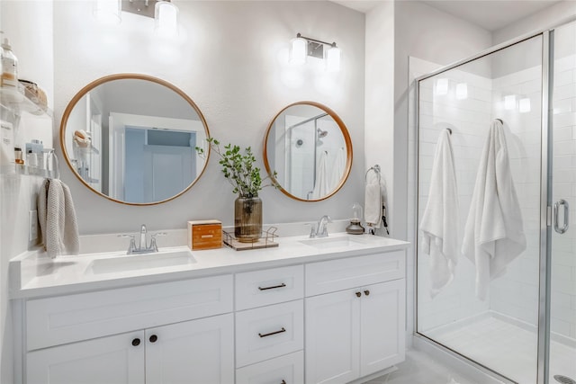 bathroom featuring vanity and a shower with door