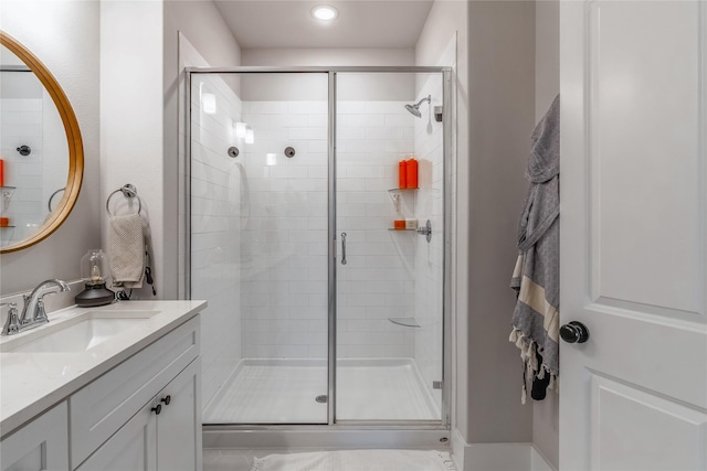 bathroom featuring tile patterned floors, vanity, and a shower with shower door