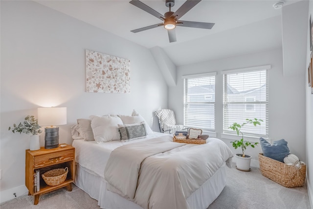 bedroom with vaulted ceiling, carpet flooring, and ceiling fan