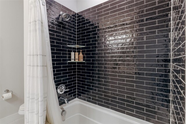 bathroom with shower / bath combo and toilet