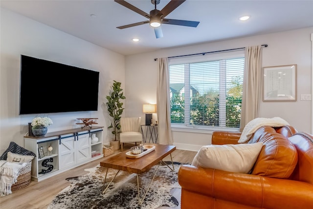 living room featuring light wood-type flooring and ceiling fan