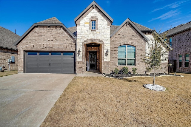 french country inspired facade featuring a front yard and a garage