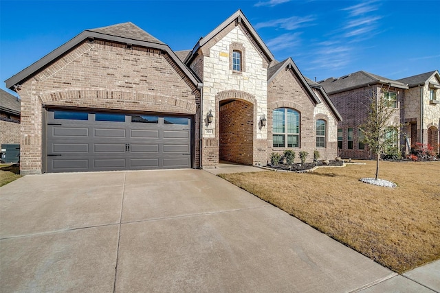 french country style house with a front yard, a garage, and cooling unit