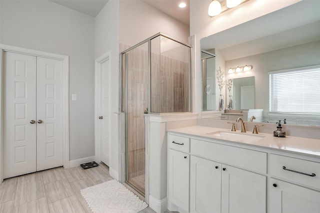 bathroom featuring an enclosed shower and vanity