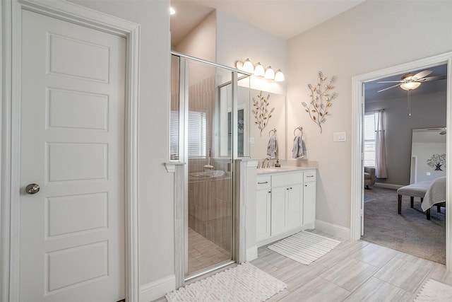 bathroom with ceiling fan, vanity, and a shower with shower door