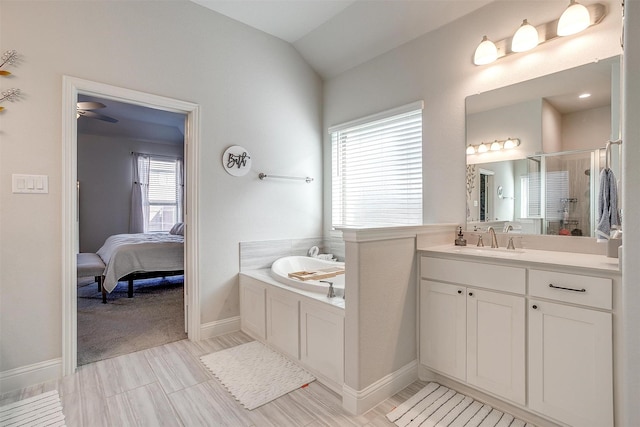 bathroom with shower with separate bathtub, vanity, ceiling fan, and vaulted ceiling