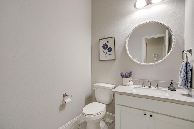 bathroom featuring toilet, tile patterned flooring, and vanity