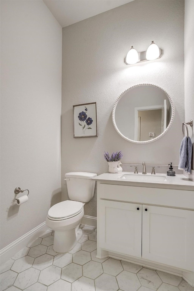 bathroom with tile patterned floors, vanity, and toilet