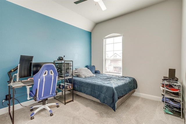 carpeted bedroom with ceiling fan and vaulted ceiling