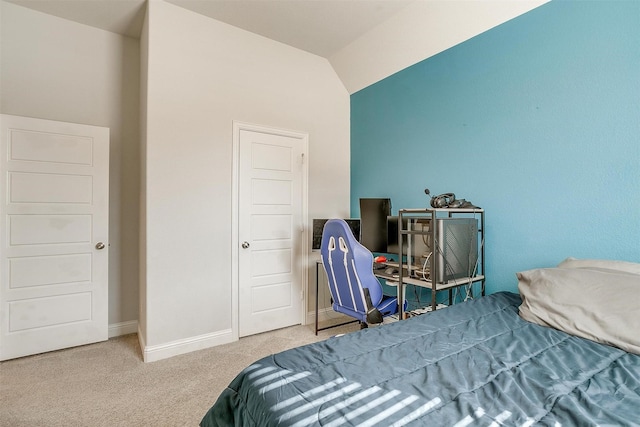 bedroom featuring carpet and vaulted ceiling