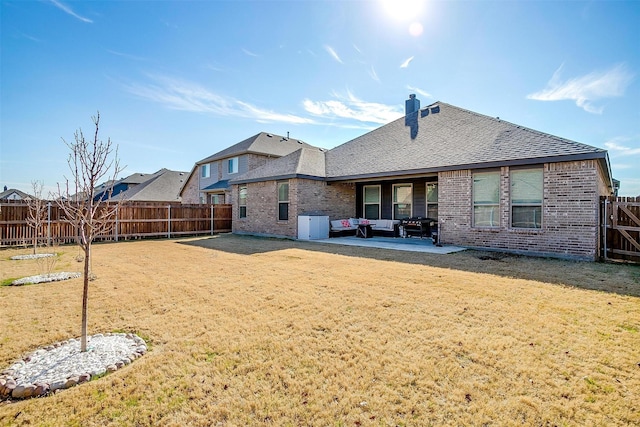 back of house with a yard, central air condition unit, and a patio area