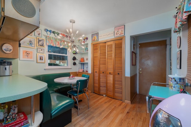 dining area featuring an inviting chandelier and light hardwood / wood-style floors