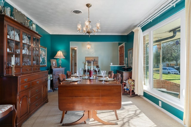 carpeted home office featuring a notable chandelier