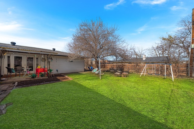 view of yard with a patio, french doors, and a playground