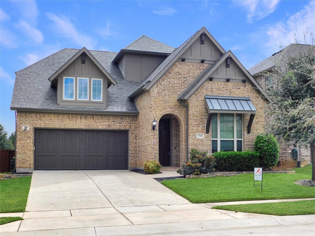 view of front of home with a front lawn and a garage