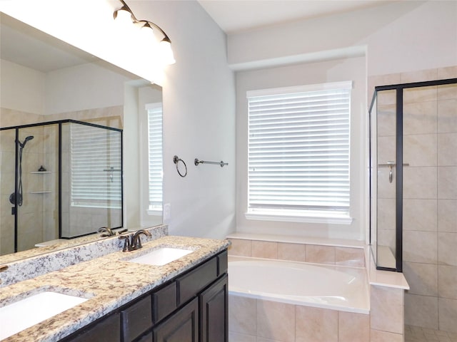 bathroom with shower with separate bathtub and vanity