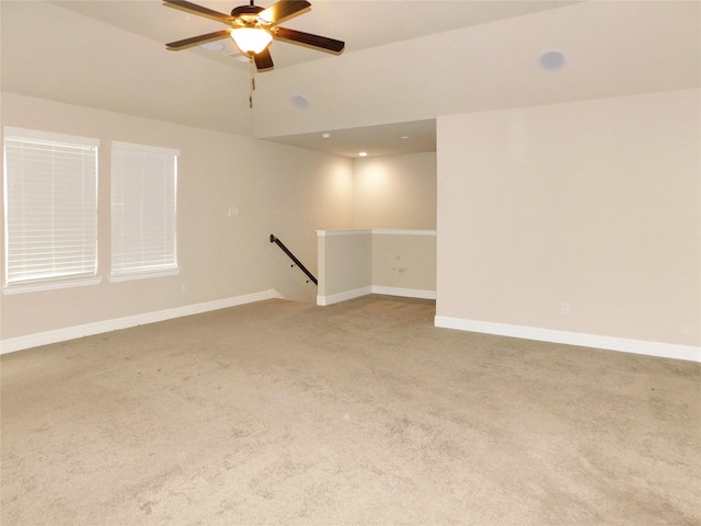 spare room with ceiling fan and carpet