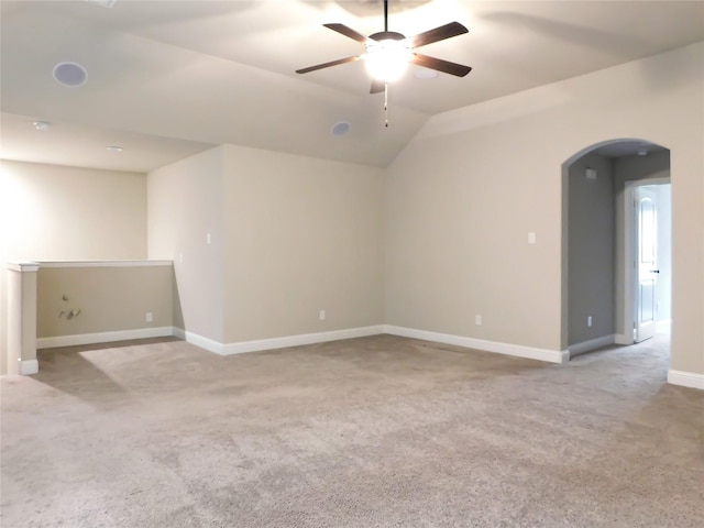 unfurnished room with ceiling fan, light colored carpet, and lofted ceiling