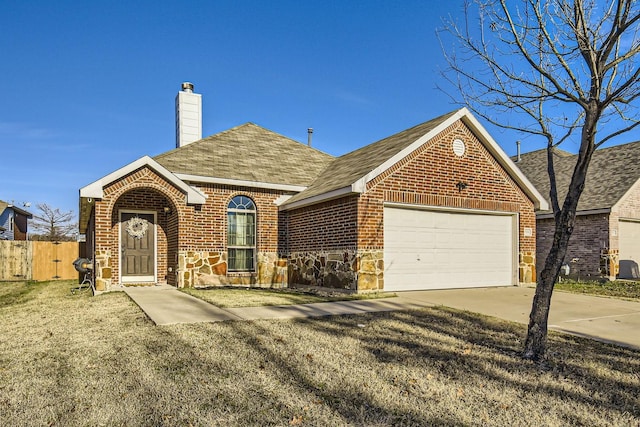 view of front of property with a front lawn and a garage