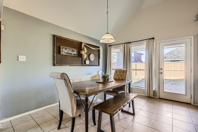 tiled dining area with high vaulted ceiling