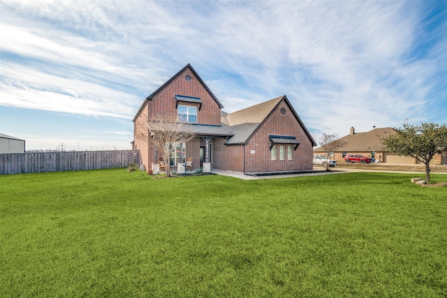 rear view of property featuring a lawn